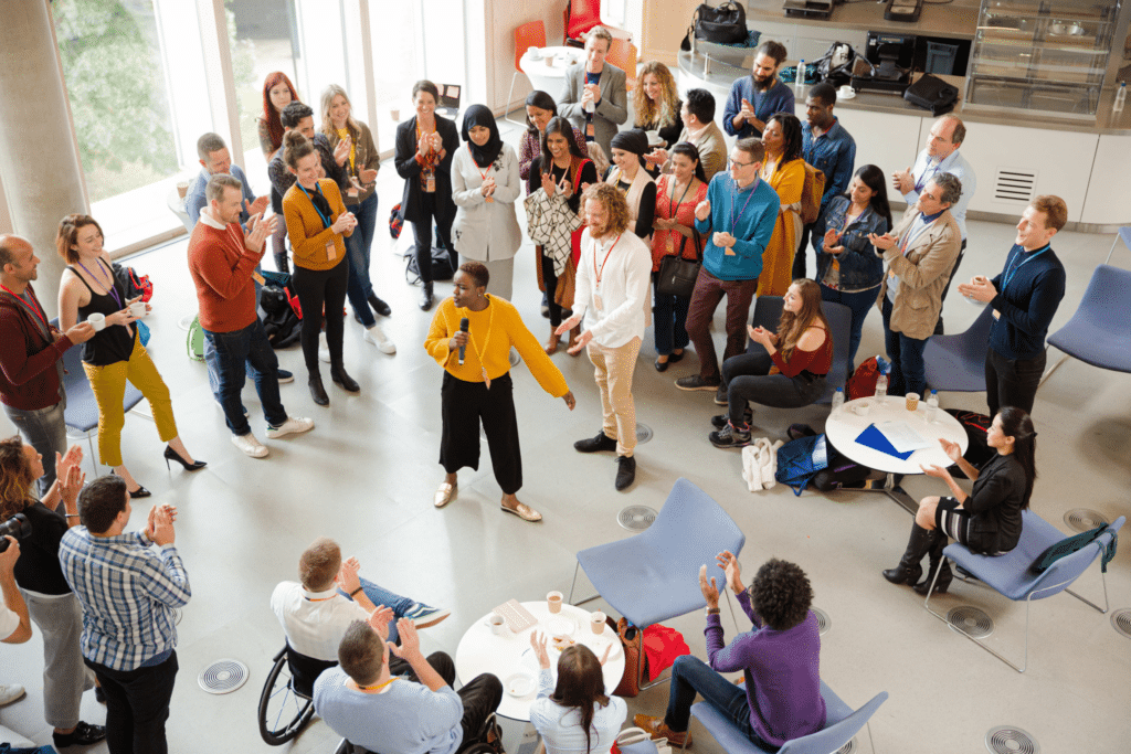 a woman with a microphone leading a workshop event