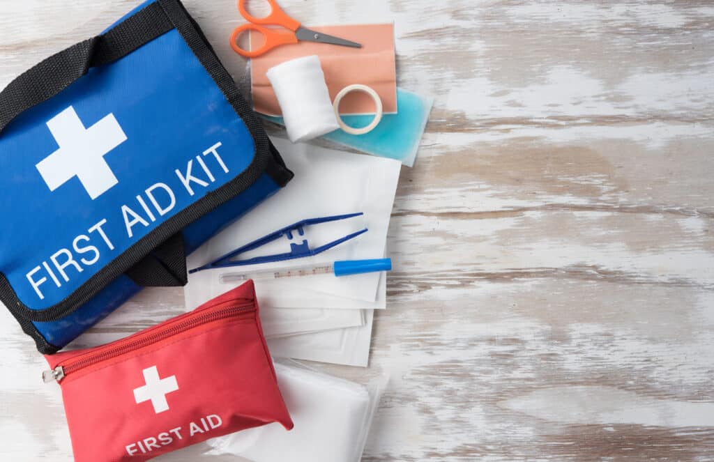 First aid medical kit on wood background,top view